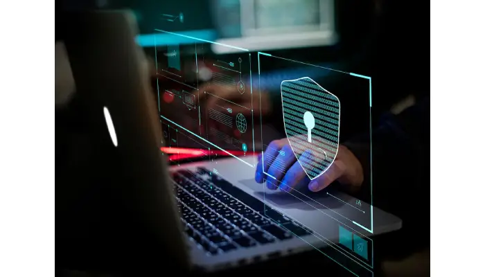 Data breach response team analyzing cybersecurity threats on a computer with digital security icons