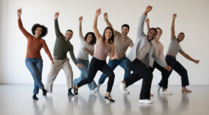 Diverse adults of varying ages and body types dancing joyfully in a bright, modern studio, representing adult dance classes in Toronto.