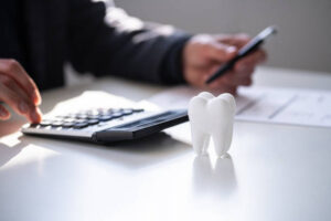 Patient reviewing dental treatment cost comparison between clinic and dental school