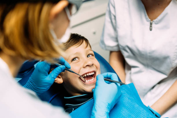 Parent and child at dental checkup exploring Is Aspen Dental Good for Families considering pediatric dental care options